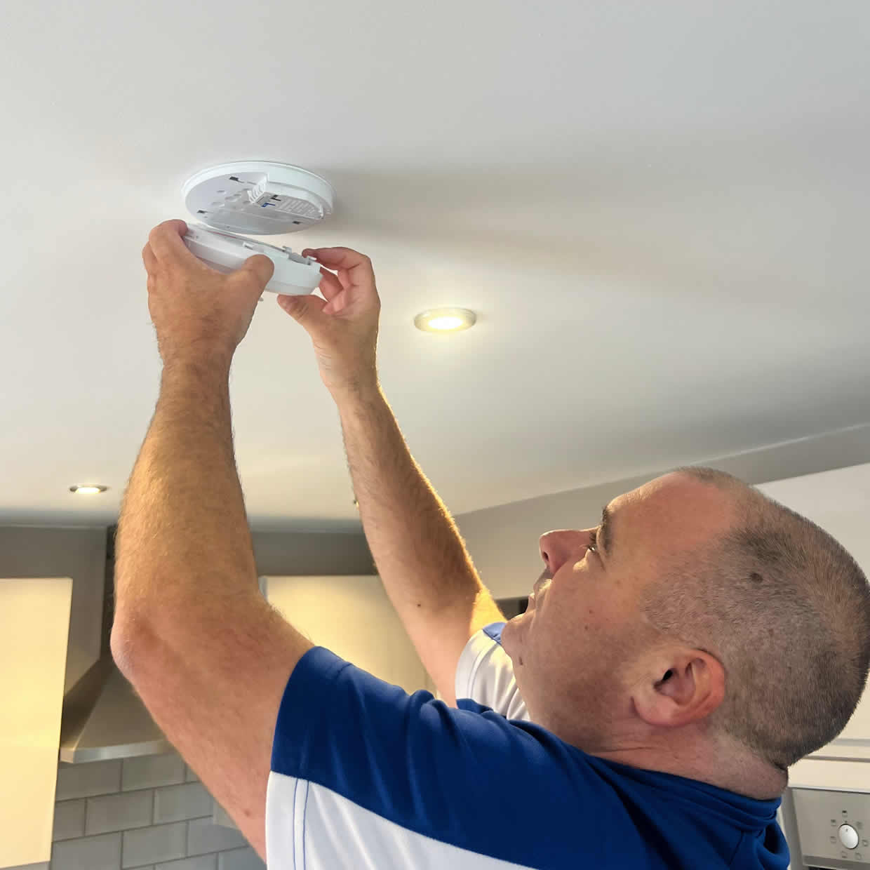 Smoke alarm being installed on a ceiling in Chatham